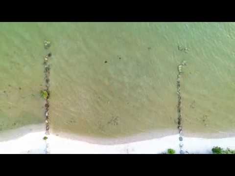 Video clip of a drone flying over water.